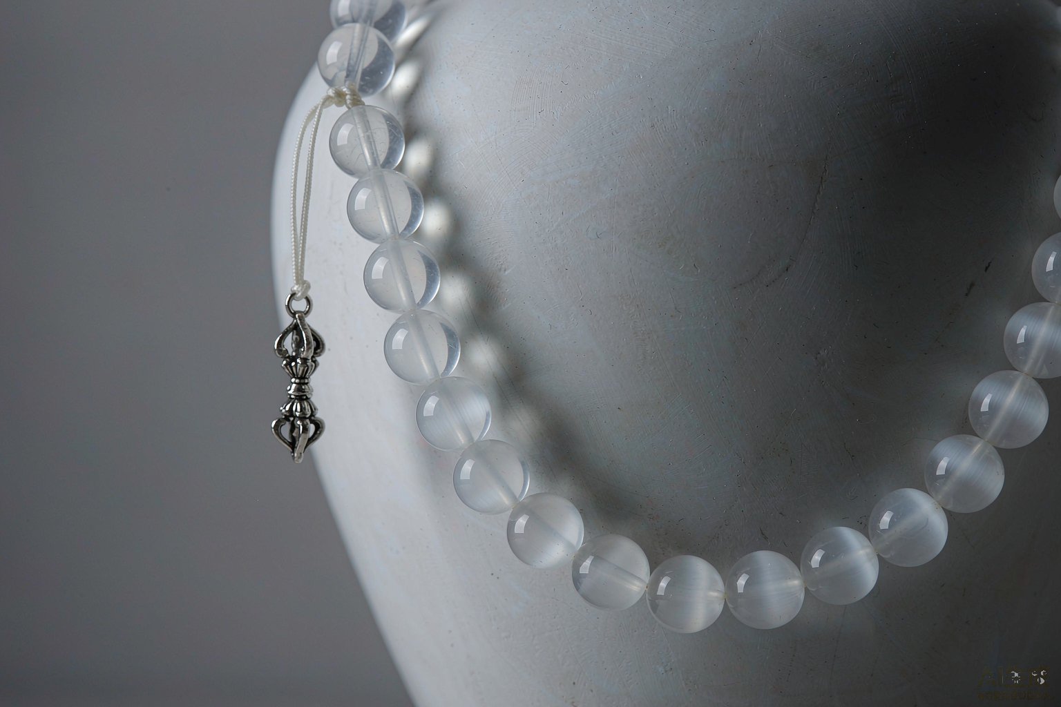 White and clear crystal mala beads with a small silver vajra pendant